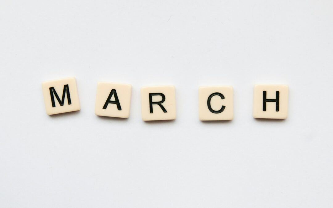 March spelled out in scrabble letters on white background